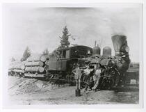 Men standing in front of lumber train