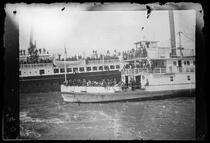 Troops aboard steamship departing for Philippines, with ferryboat Herald in foreground, San Francisco Bay