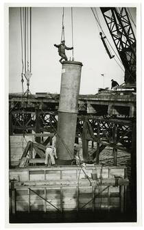 Golden Gate Bridge construction worker on concrete pillar