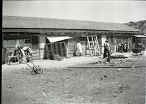 Woman and man working outside a wooden structure
