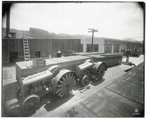 View of two sizes of Faqeol tractors at the Faqeol plant, Oakland, California, between 1910 and 1919