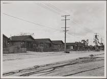 Japanese row houses, Terminal Way, Terminal Island; fishing nets in foreground