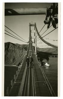 Golden Gate Bridge construction workers standing on cables