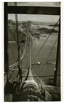 View of cargo ship passing beneath Golden Gate Bridge construction