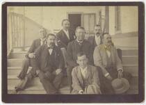 Reginaldo F. del Valle and unidentified men seated on steps