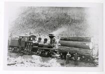 Men with a lumber-hauling train engine