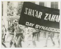 Bob Stein bearing Sha'ar Zahav, gay synagogue banner, Market St.