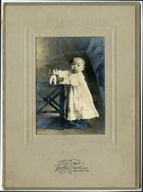 Studio portrait of infant in gown
