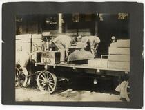 Agricultural laborers unloading boxes of raisins in Selma, Fresno County, California 