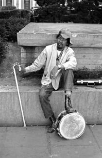 Man with briefcase plays snare drum in Union Square