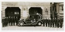 Fire fighters of Engine Co. No. 28, with car decorated with flowers for parade, Los Angeles