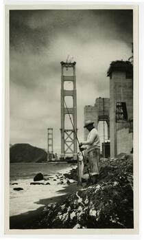 Man fishing, partial Golden Gate Bridge in background