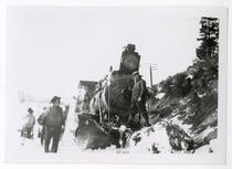 Snowy scene with men and an engine