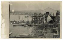 Busy port scene with fishing boats in foreground