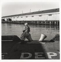 Woman fishing on the waterfront, San Francisco